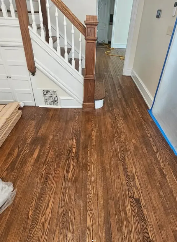 Worn hardwood floor before refinishing